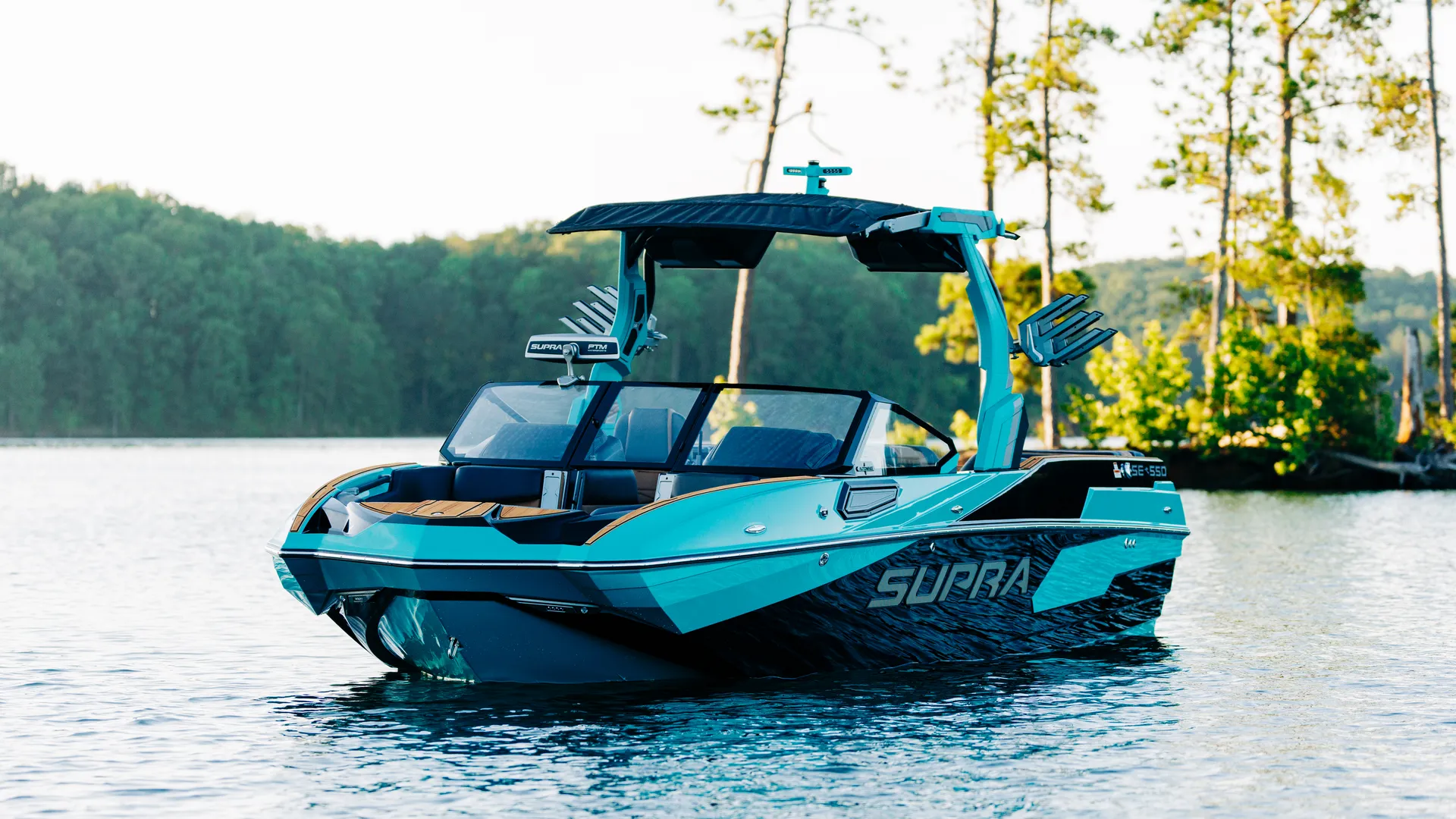 A teal and black 2026 Supra SE sitting idle in the lake during sunset. 