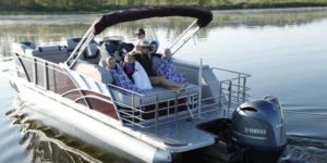A family enjoys a day on the lake in a cruising boat.