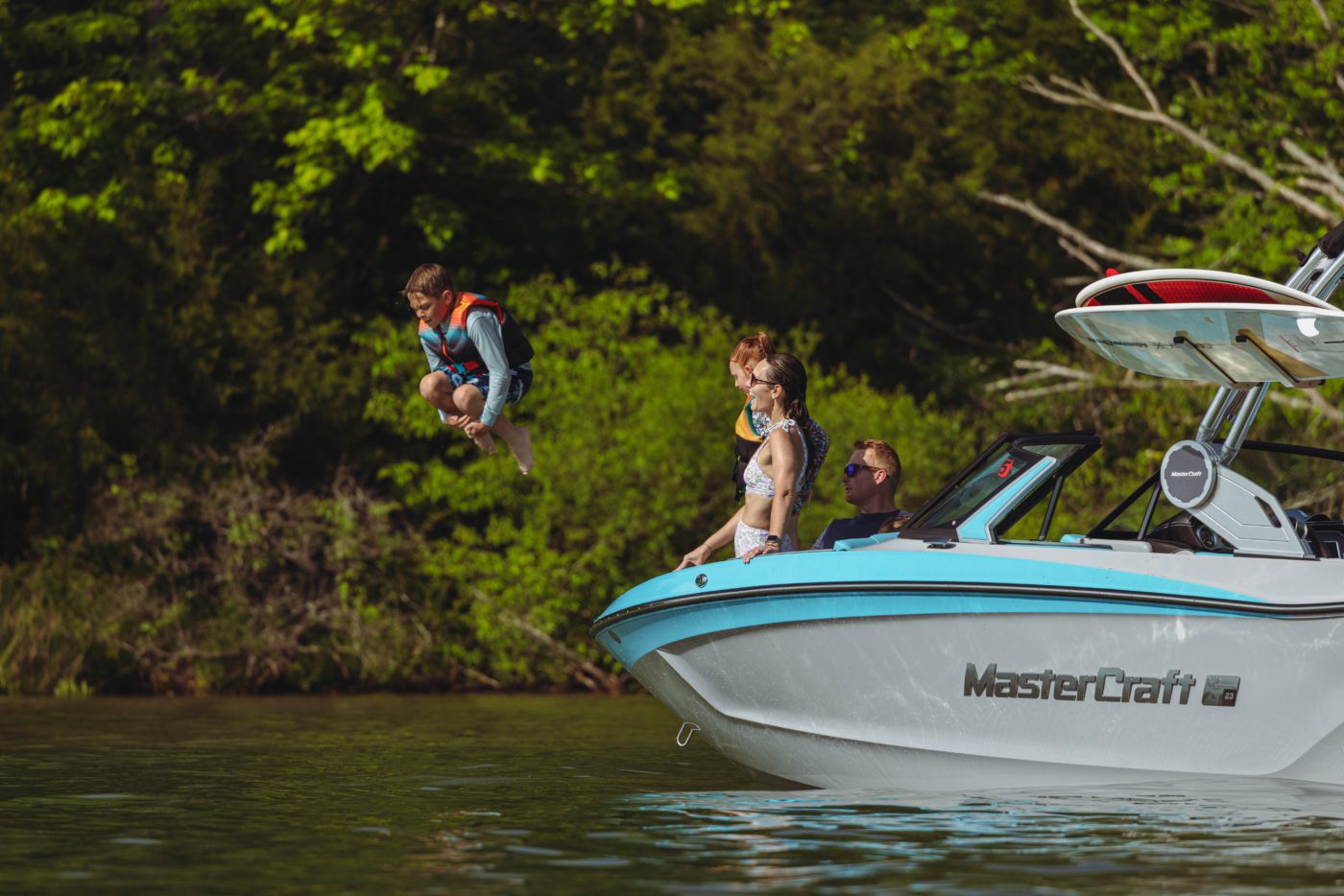A child jumping off of a MasterCraft