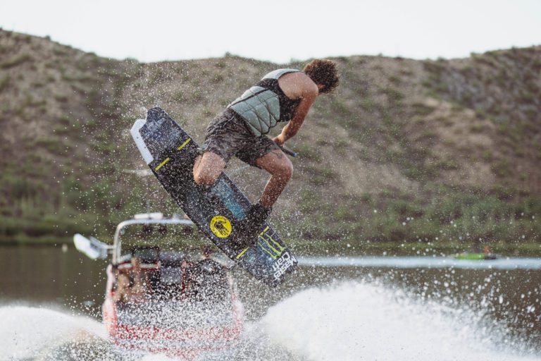 A wake boarder behind a 2023 MasterCraft boat