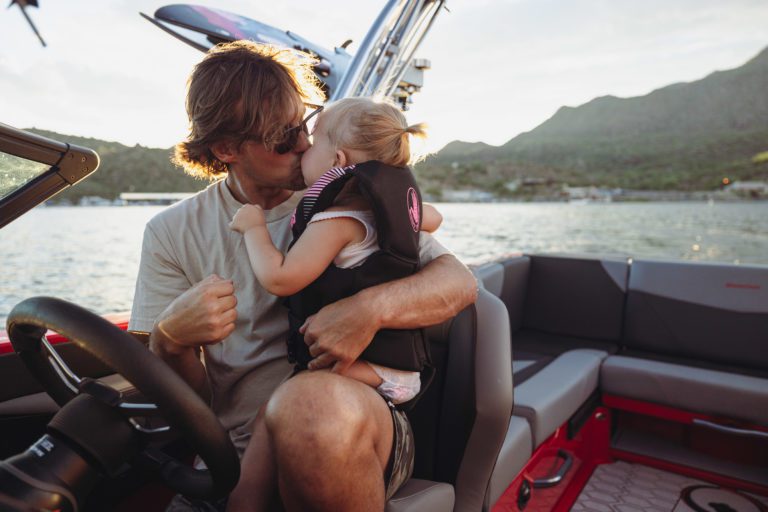 A father and daughter spend time on the water.