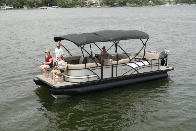 A long bimini covers a family from weather.