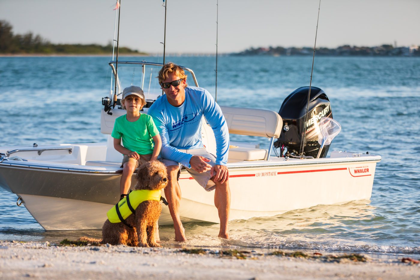 A family sits beside a Boston Whaler.