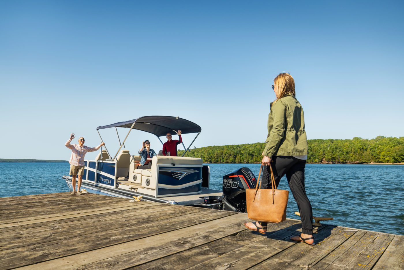 A family heads to their Premier Pontoon on the dock.