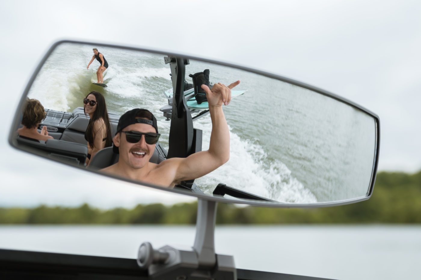 A group of friends having fun on a wake boat.