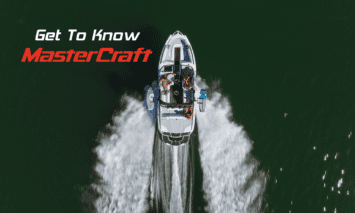 A MasterCraft wake boat creates waves on the water.