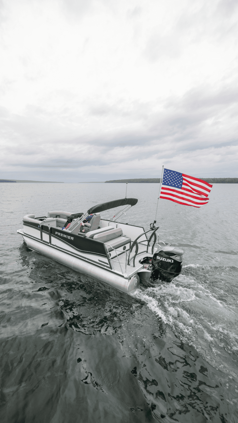A premier pontoon with a flag attached to it.