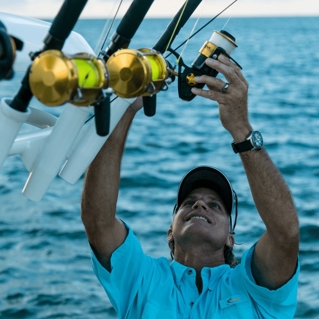 An angler grabbing his rods on a 250 Outrage.