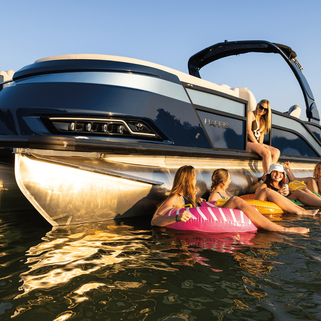 A family hangs out by a 2024 pontoon