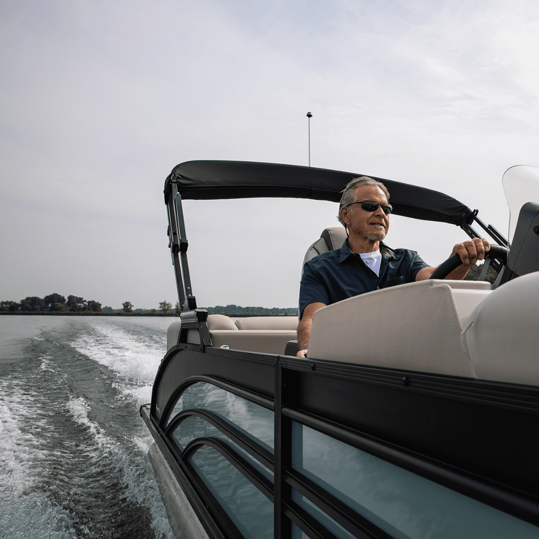 A man takes his new Harris Pontoon Sunliner out on the water