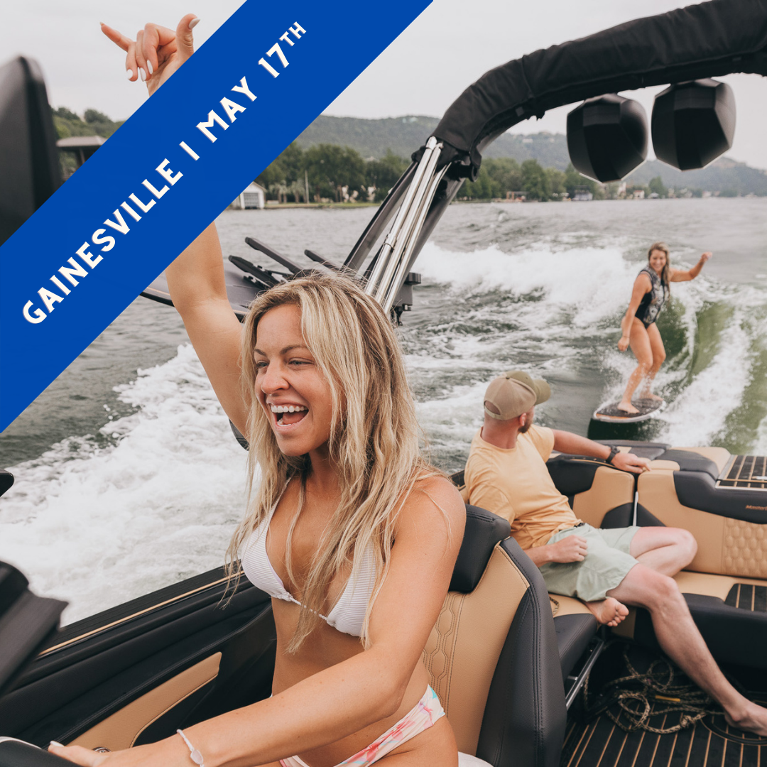 Friends on a boat with a wakesurfer behind them during a MasterCraft Rule The Water event