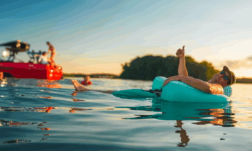 An image of a man enjoying the water next to a Moomba wake boat