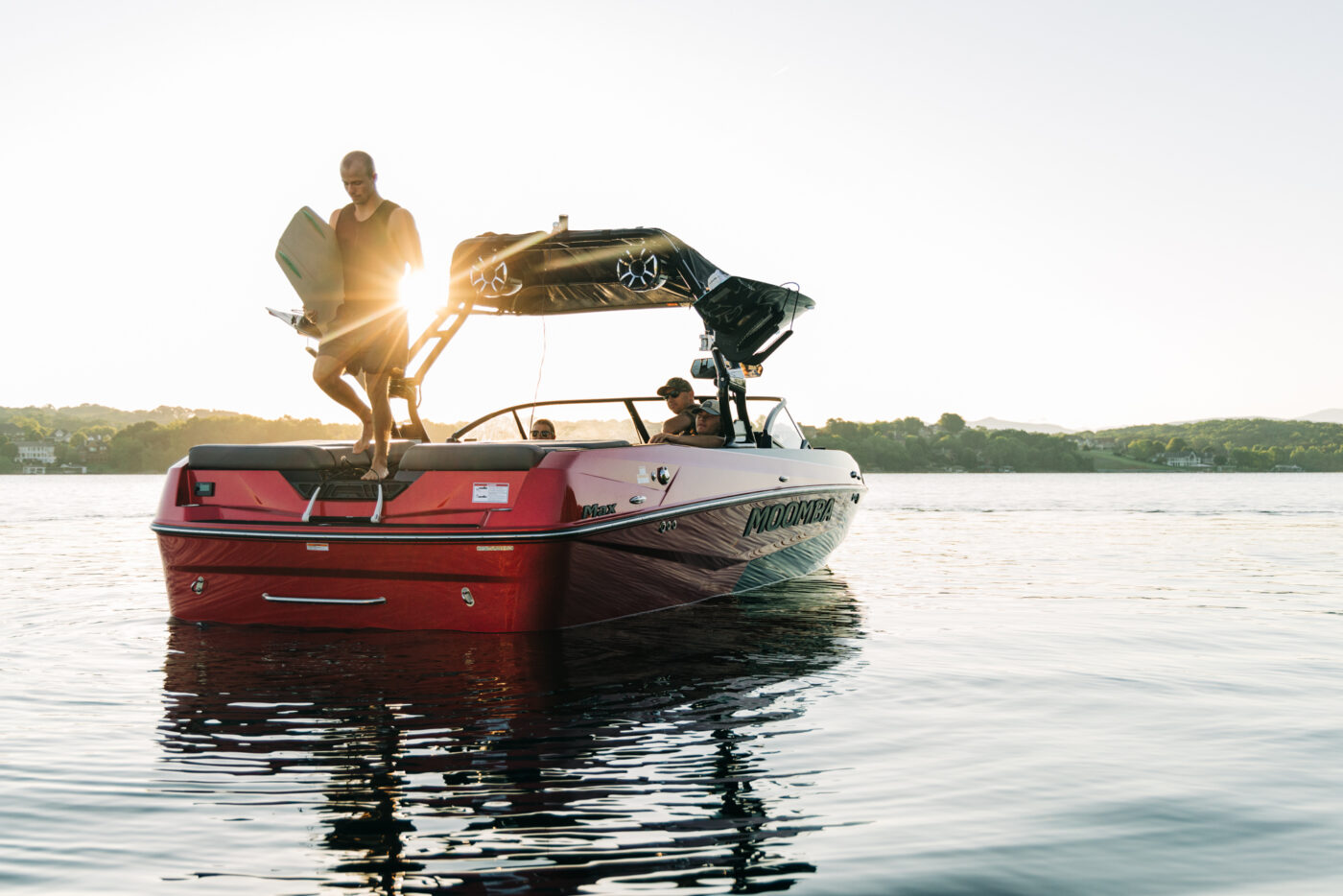 A wake surfer steps off a 2025 Moomba Max to catch waves.
