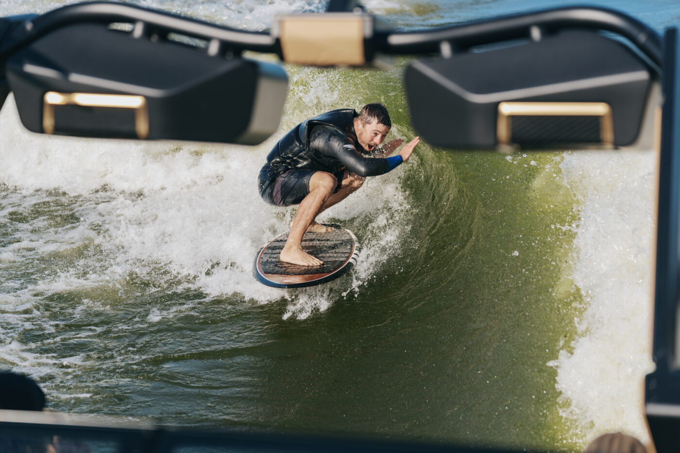 A wakesurfer catching waves behind a new MasterCraft XStar 23