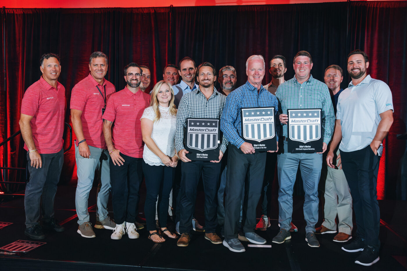 A group of Skier's Marine team members with MasterCraft awards.