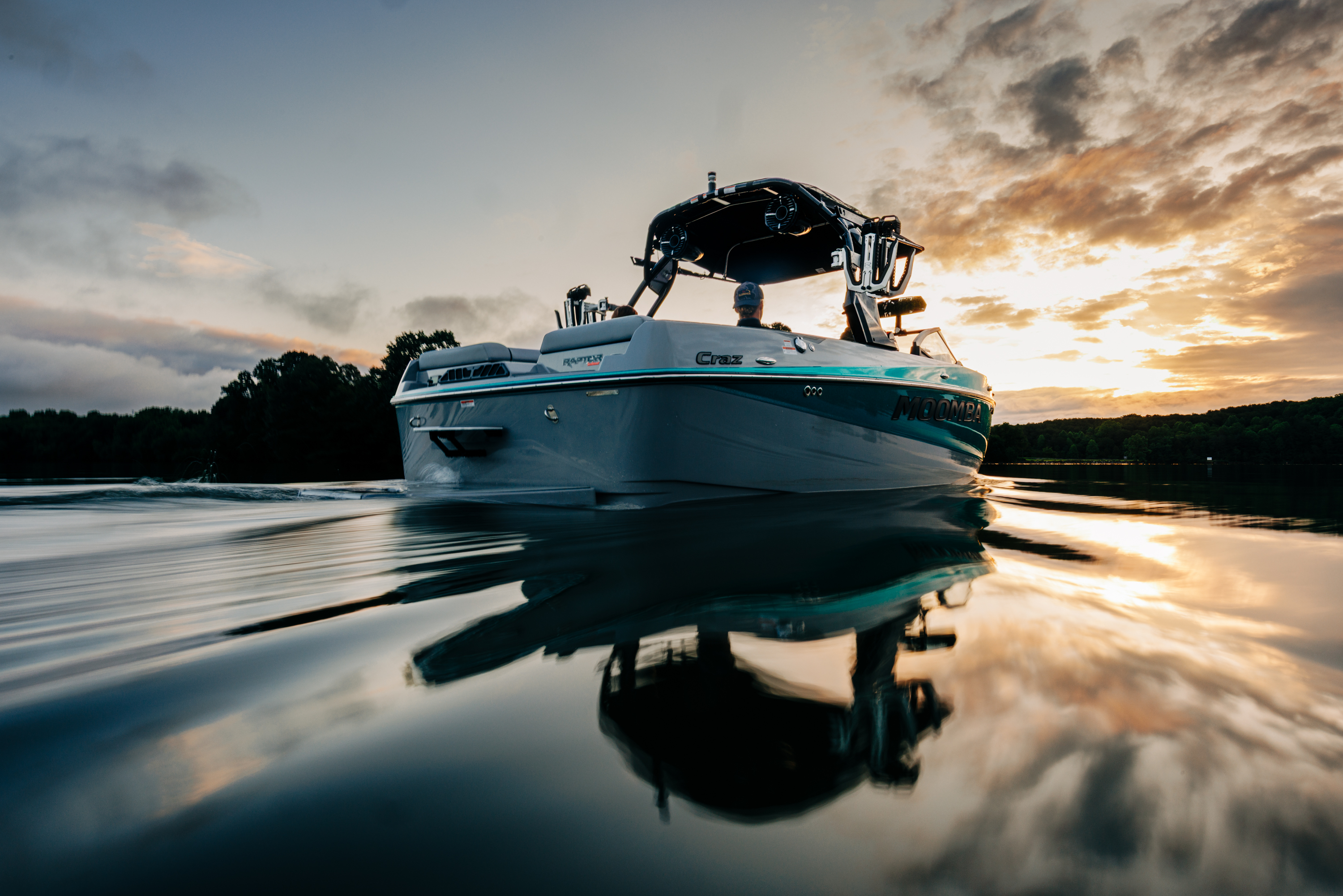 A Moomba Craz sitting idle in the lake as the sun sets.