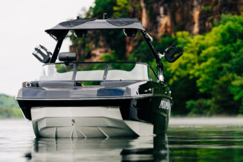 Black and white Moomba wake boat sitting in the water.