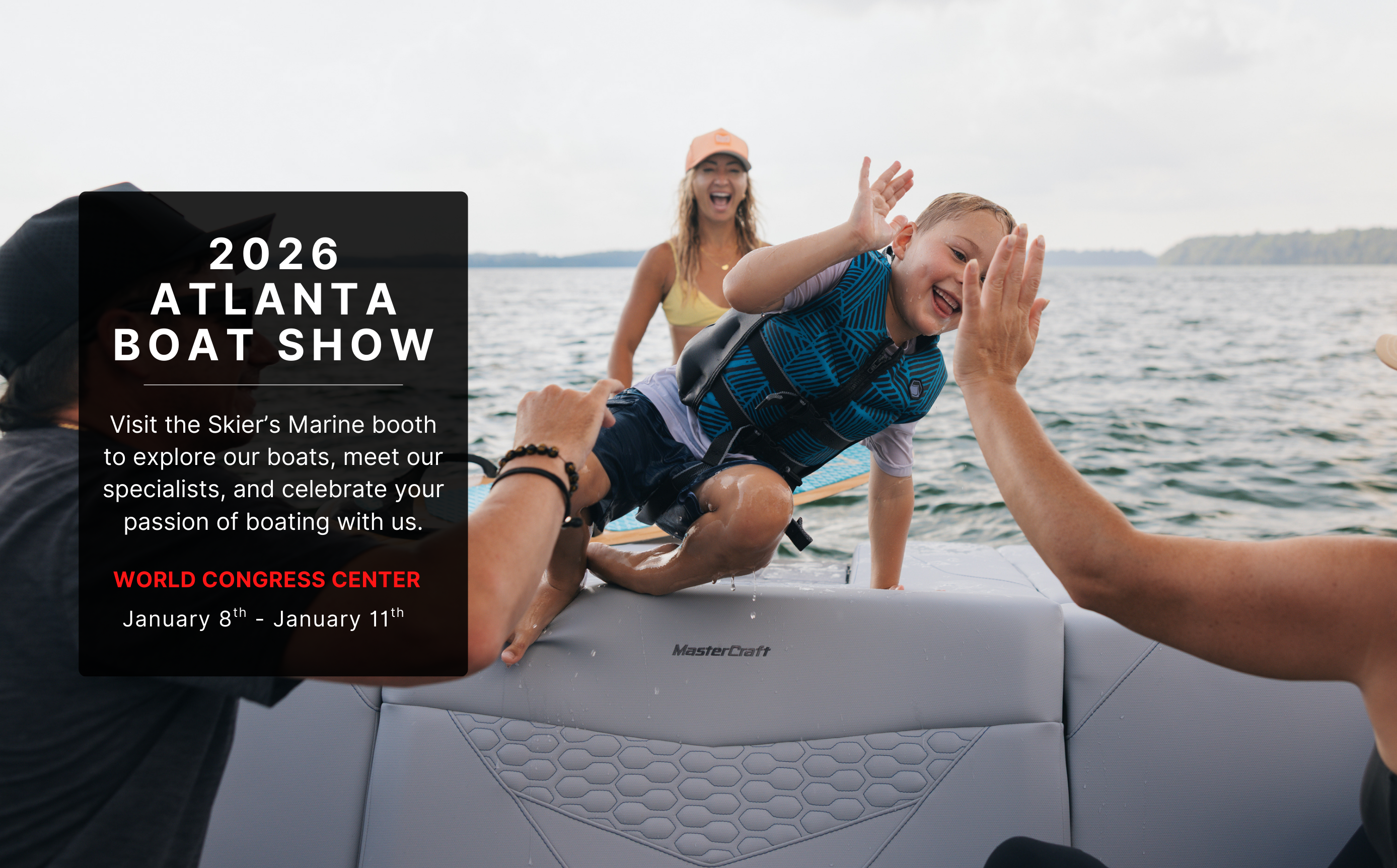 A young boy getting out of the water after a surfing session behind a MasterCraft wake boat.